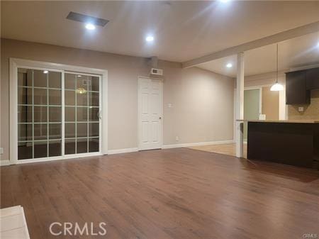 unfurnished living room with recessed lighting, baseboards, and wood finished floors