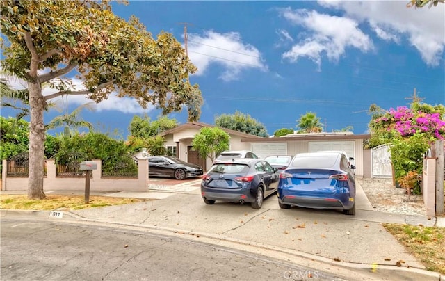 view of front of home featuring a gate, a garage, and driveway