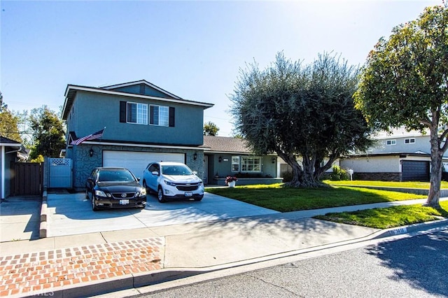 traditional home with a front yard, fence, an attached garage, stucco siding, and concrete driveway