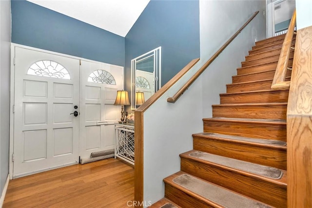 foyer with stairs and light wood-style floors