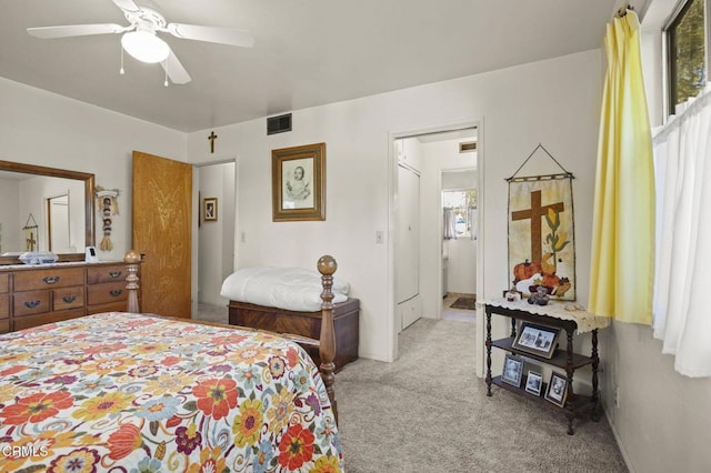 bedroom featuring visible vents, light colored carpet, and ceiling fan