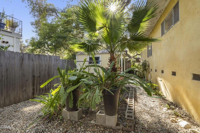 view of yard featuring an outbuilding and fence