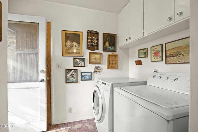 laundry room featuring brick floor, cabinet space, independent washer and dryer, and baseboards