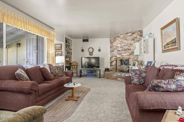 carpeted living area featuring visible vents, built in shelves, and a fireplace