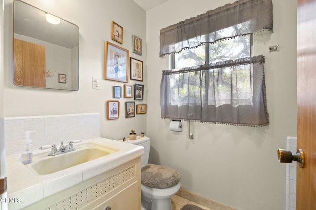 half bath featuring toilet and vanity