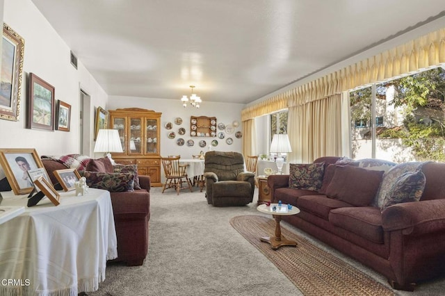 living area featuring an inviting chandelier, carpet flooring, and visible vents