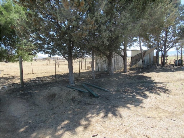 view of yard featuring a rural view and fence