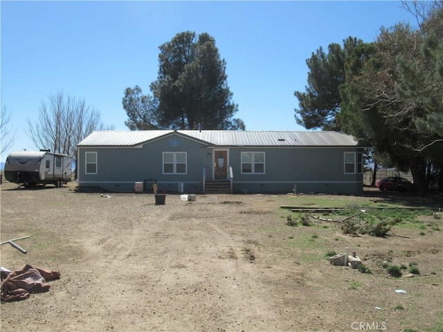 view of front of house featuring metal roof and crawl space