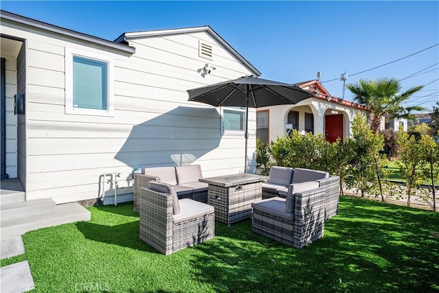 back of house with an outdoor hangout area and a yard