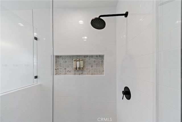 full bath featuring a tile shower