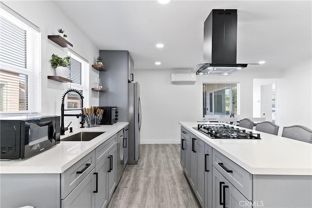 kitchen with open shelves, gray cabinets, and island range hood