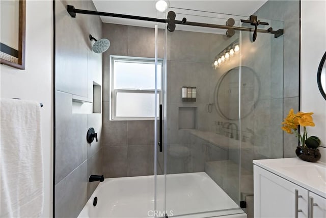 full bathroom with vanity and bath / shower combo with glass door