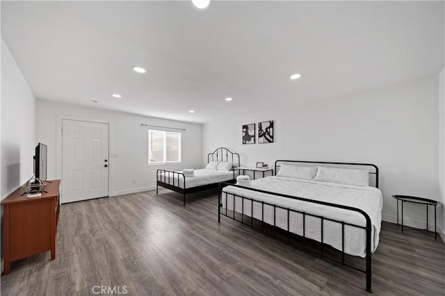 bedroom with recessed lighting, baseboards, and wood finished floors