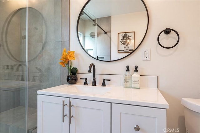 full bath featuring vanity, a shower stall, and toilet