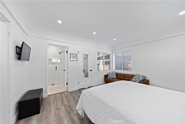 bedroom with recessed lighting, ensuite bathroom, baseboards, and wood finished floors