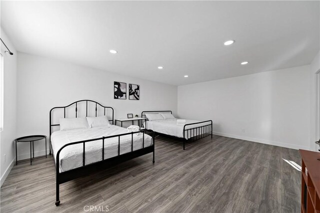 bedroom featuring recessed lighting, wood finished floors, and baseboards