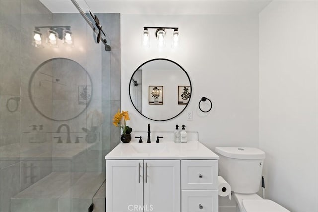 bathroom with vanity, a shower stall, and toilet