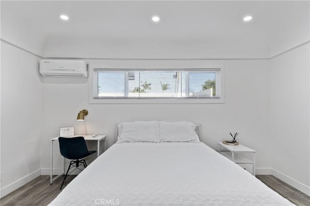 bedroom with recessed lighting, dark wood-style flooring, a wall mounted air conditioner, and baseboards