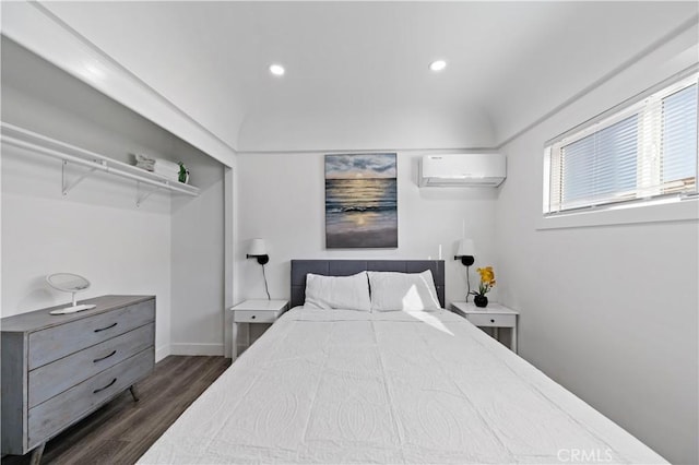 bedroom with an AC wall unit, recessed lighting, dark wood-style floors, and baseboards