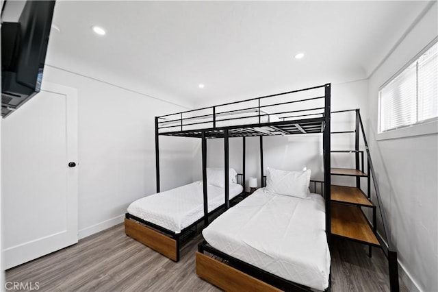 bedroom with recessed lighting, baseboards, and wood finished floors