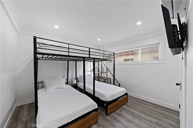 bedroom with recessed lighting, wood finished floors, and baseboards