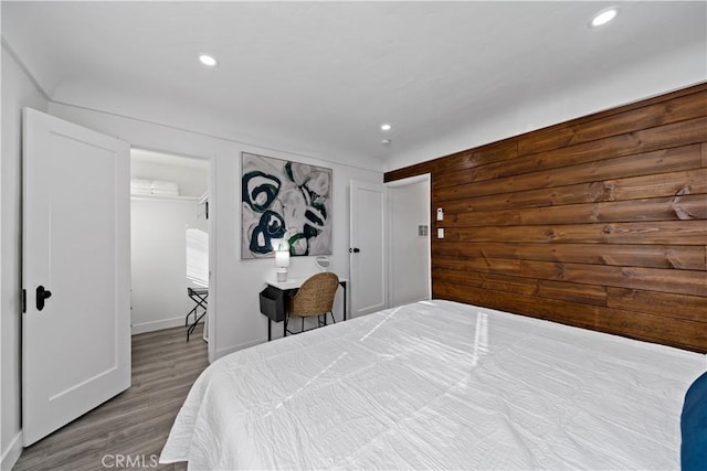 bedroom with recessed lighting and wood finished floors