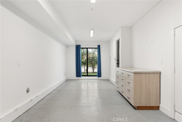 spare room featuring baseboards