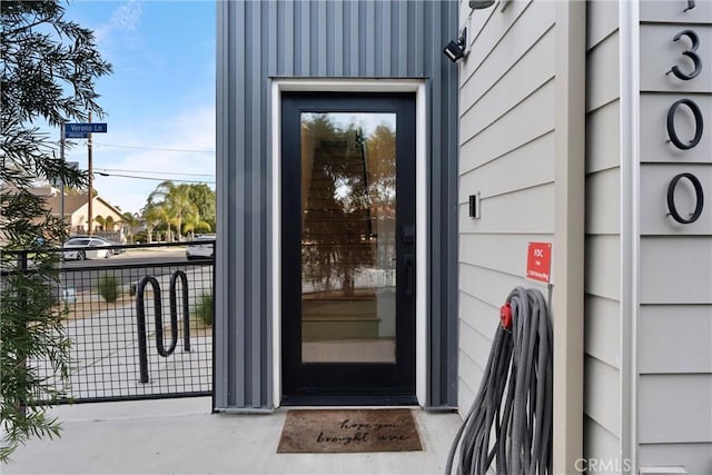 view of exterior entry featuring fence