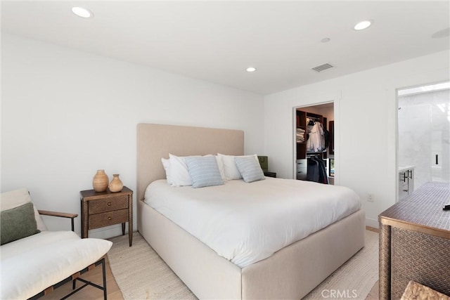 bedroom with recessed lighting, visible vents, and a walk in closet