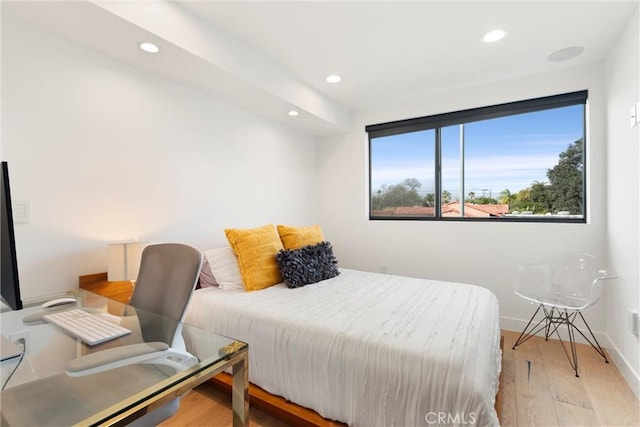 bedroom with recessed lighting, baseboards, and wood finished floors