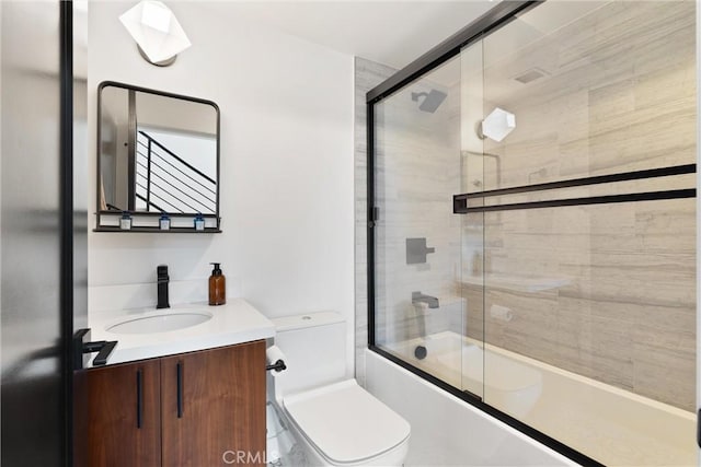 full bathroom with vanity, toilet, and enclosed tub / shower combo