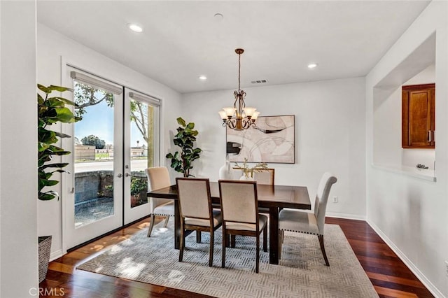 dining space with recessed lighting, baseboards, dark wood-type flooring, and a chandelier