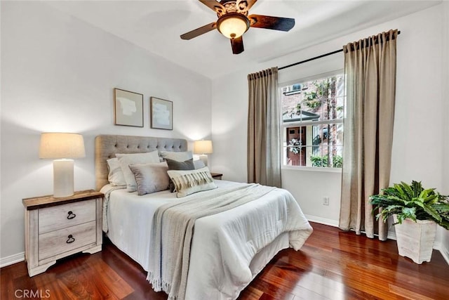 bedroom featuring ceiling fan, baseboards, and dark wood-style flooring