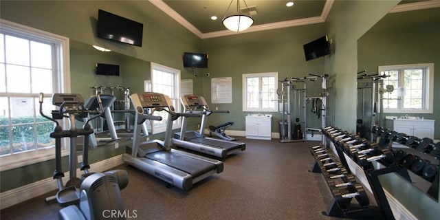 gym featuring recessed lighting, baseboards, a high ceiling, and ornamental molding