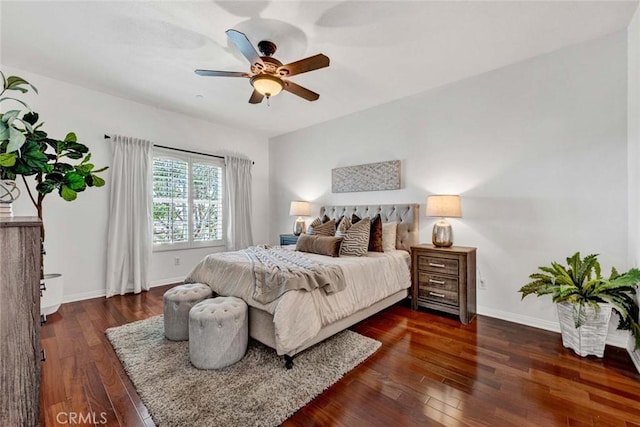 bedroom featuring hardwood / wood-style flooring, a ceiling fan, and baseboards