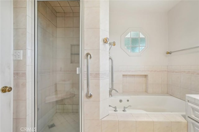 bathroom featuring a stall shower and a garden tub