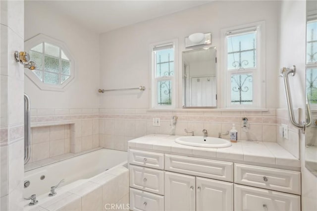 bathroom featuring a bath and vanity