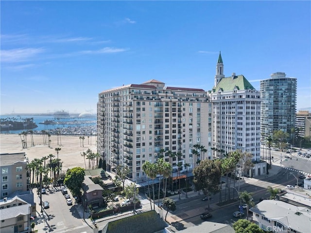 view of building exterior featuring a view of city and a water view