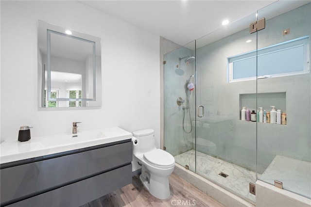 full bathroom with toilet, plenty of natural light, wood finished floors, and a stall shower