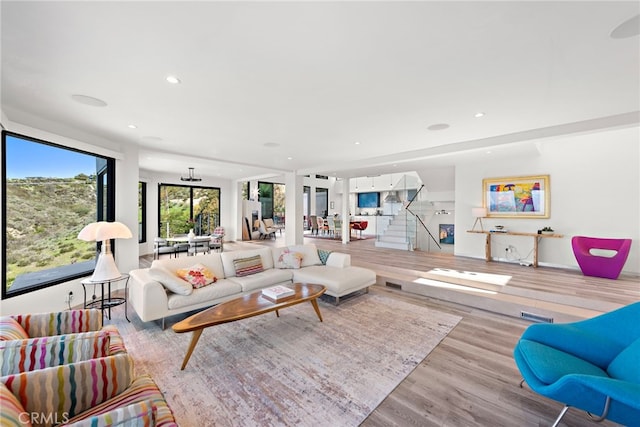 living area with stairway, recessed lighting, and wood finished floors