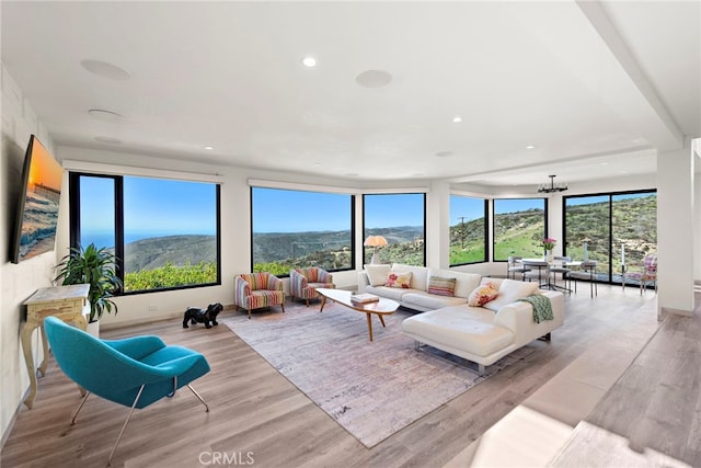 living room featuring recessed lighting, a healthy amount of sunlight, and light wood finished floors