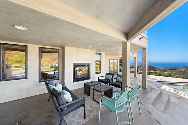 view of patio / terrace with an outdoor living space with a fireplace