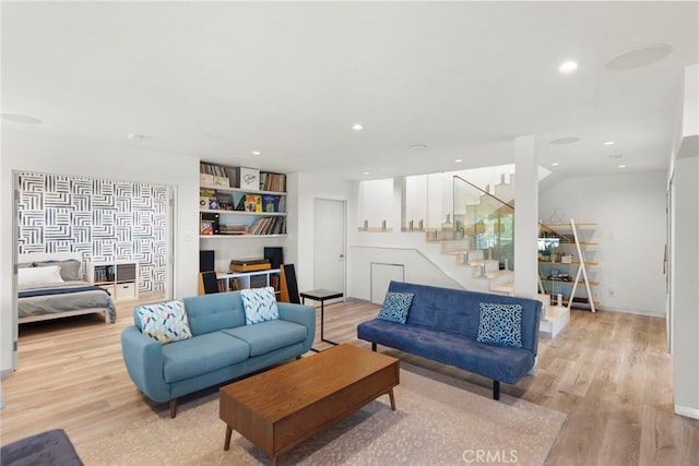 living area with recessed lighting, stairs, and wood finished floors