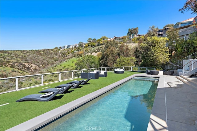 view of swimming pool featuring a yard, a fenced in pool, and fence