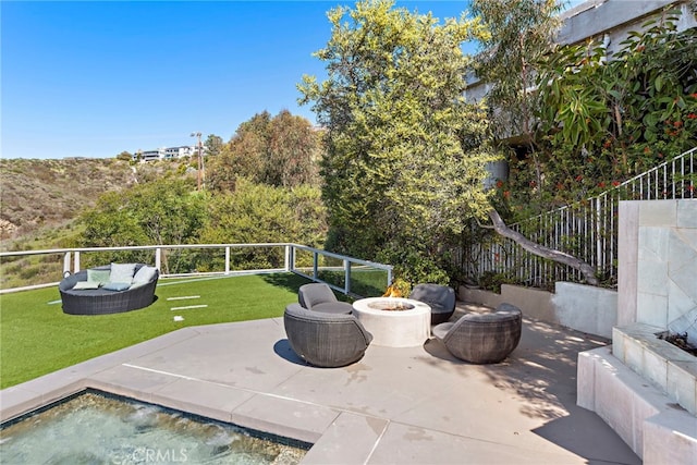 view of patio / terrace featuring an outdoor living space with a fire pit