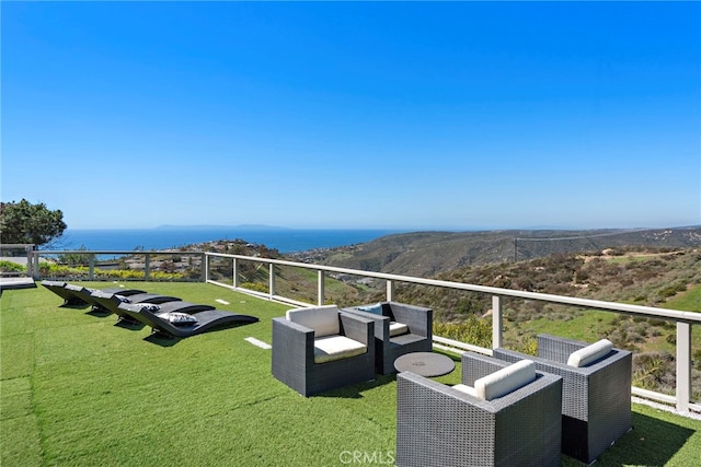 exterior space featuring a lawn and a mountain view