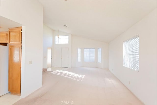 empty room featuring visible vents and high vaulted ceiling