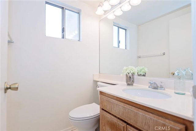 half bathroom featuring toilet and vanity