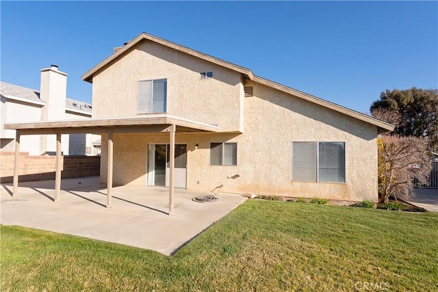 back of property featuring a patio area, stucco siding, a yard, and fence