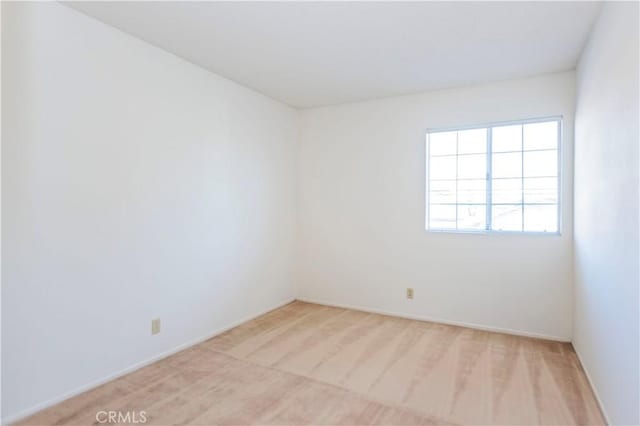 unfurnished room with light colored carpet